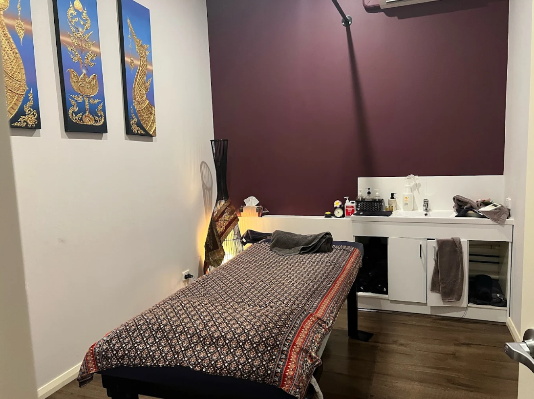 Treatment room with Thai art and burgundy accent wall